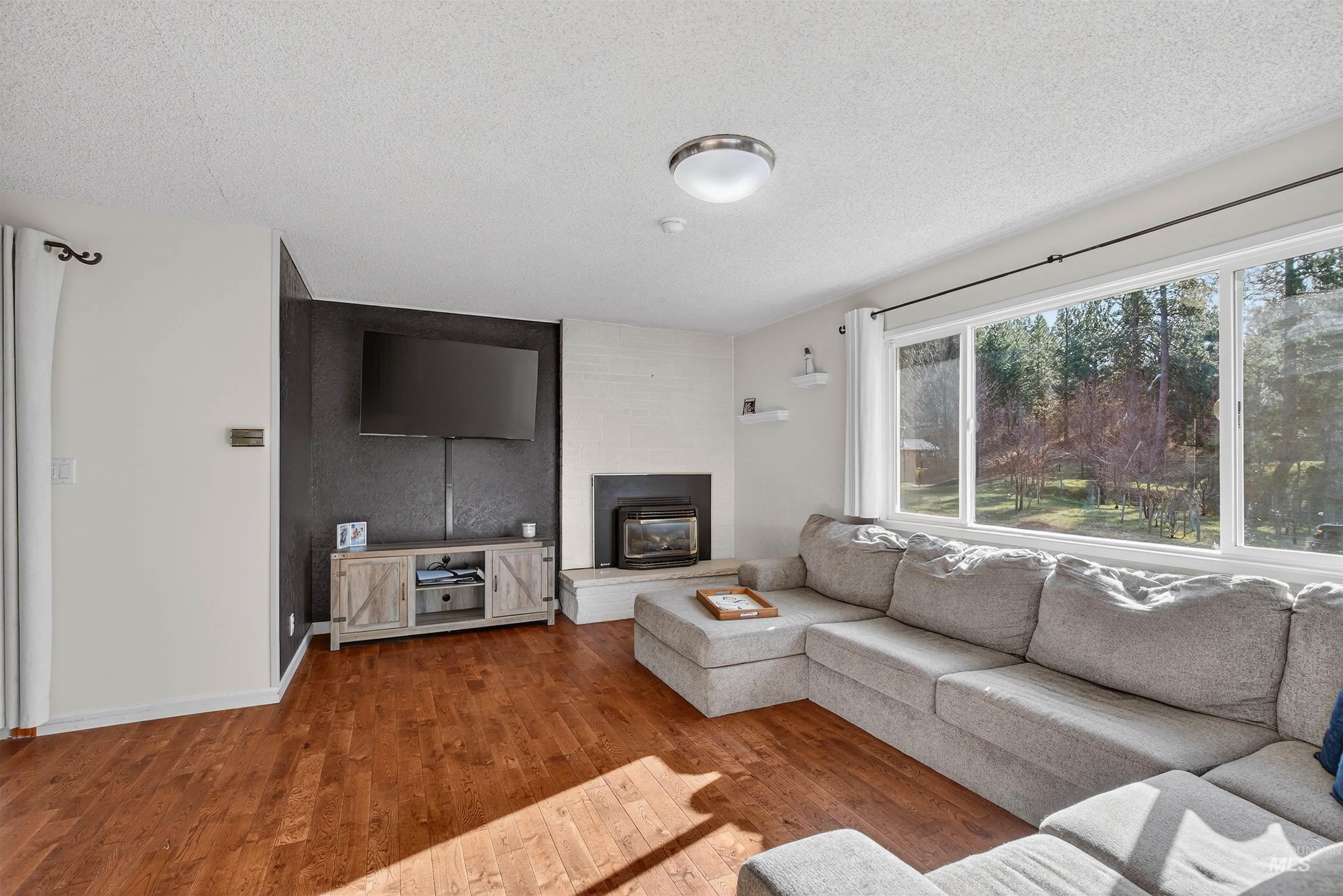 209 Walnut Drive Potlatch, ID 83855 - Photo 3 of 27 Living room with wood finished floors and a textured ceiling
