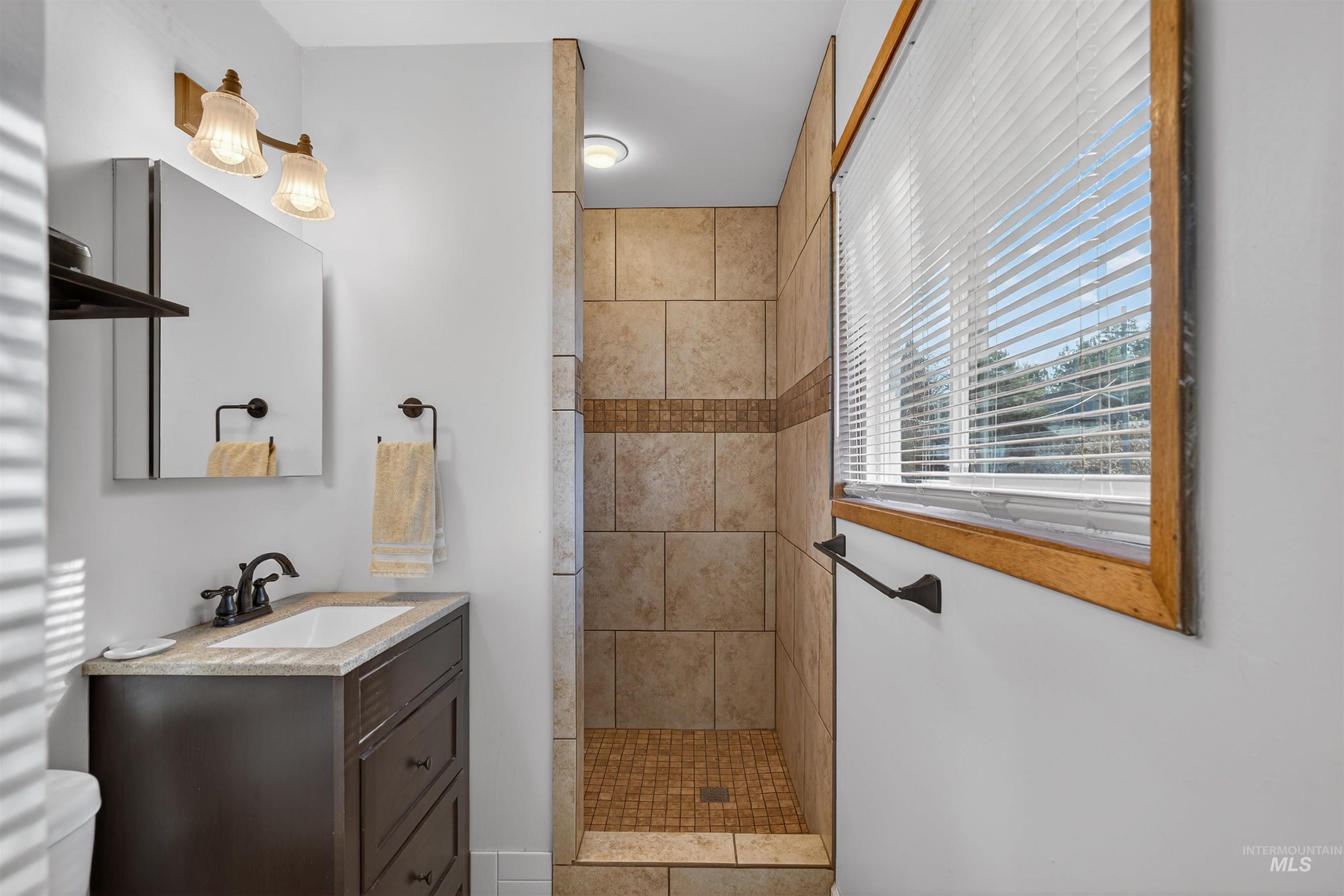 209 Walnut Drive Potlatch, ID 83855 - Photo 10 of 27 Full bathroom featuring tiled shower and vanity