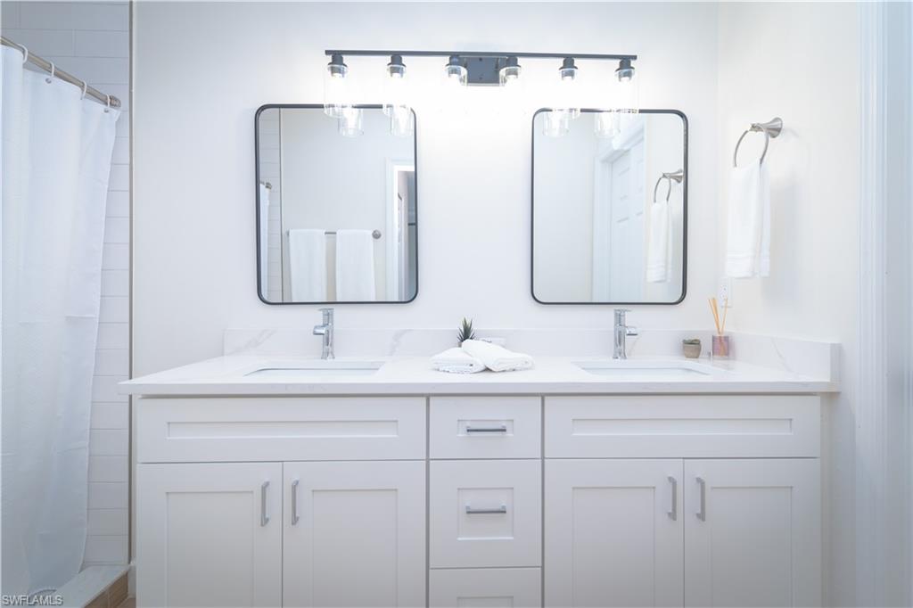9151 Irving Road Fort Myers, FL 33967 - Photo 13 of 44 Full bath featuring double vanity and a shower with shower curtain