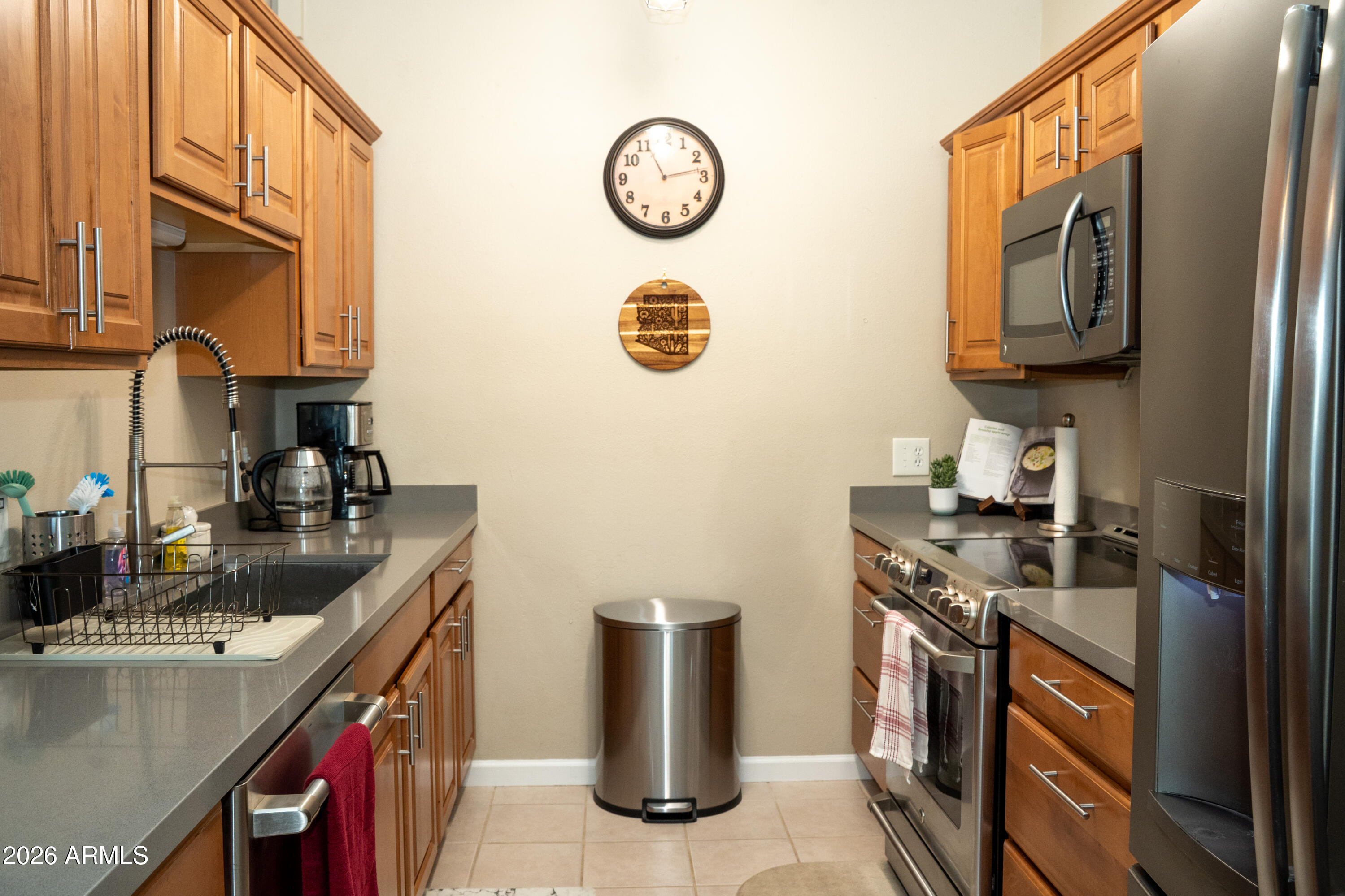 4313 North 28th Street Phoenix, AZ 85016 - Photo 10 of 26 a kitchen with stainless steel appliances granite countertop a stove a sink and a refrigerator