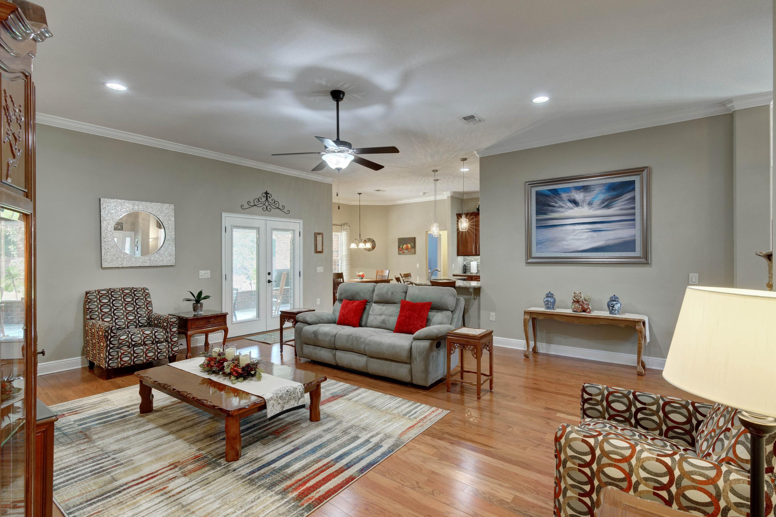 2592 Crescent Road Navarre, FL 32566 - Photo 12 of 67 a living room with furniture and wooden floor