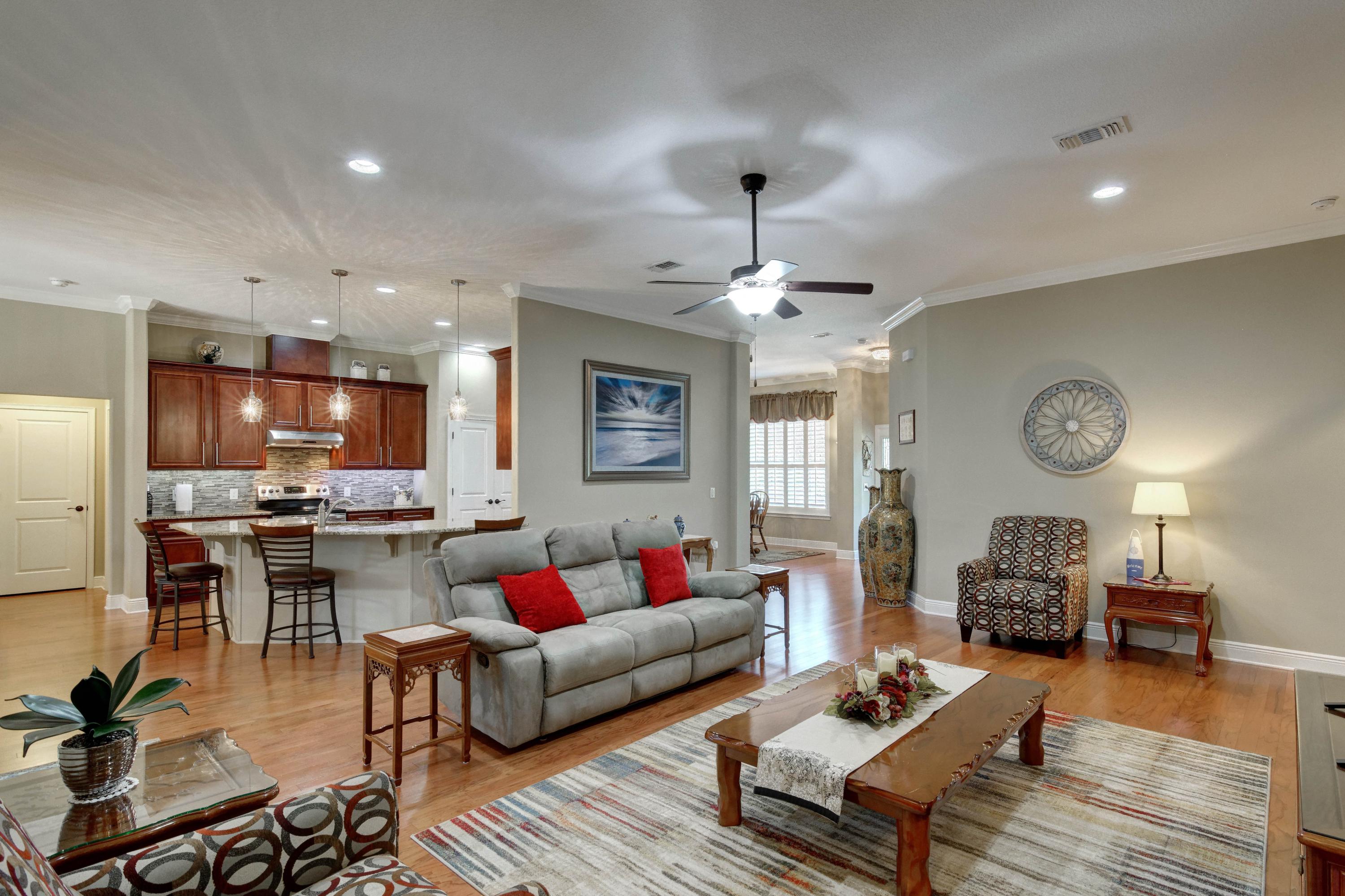2592 Crescent Road Navarre, FL 32566 - Photo 13 of 67 a living room with furniture kitchen view and a chandelier