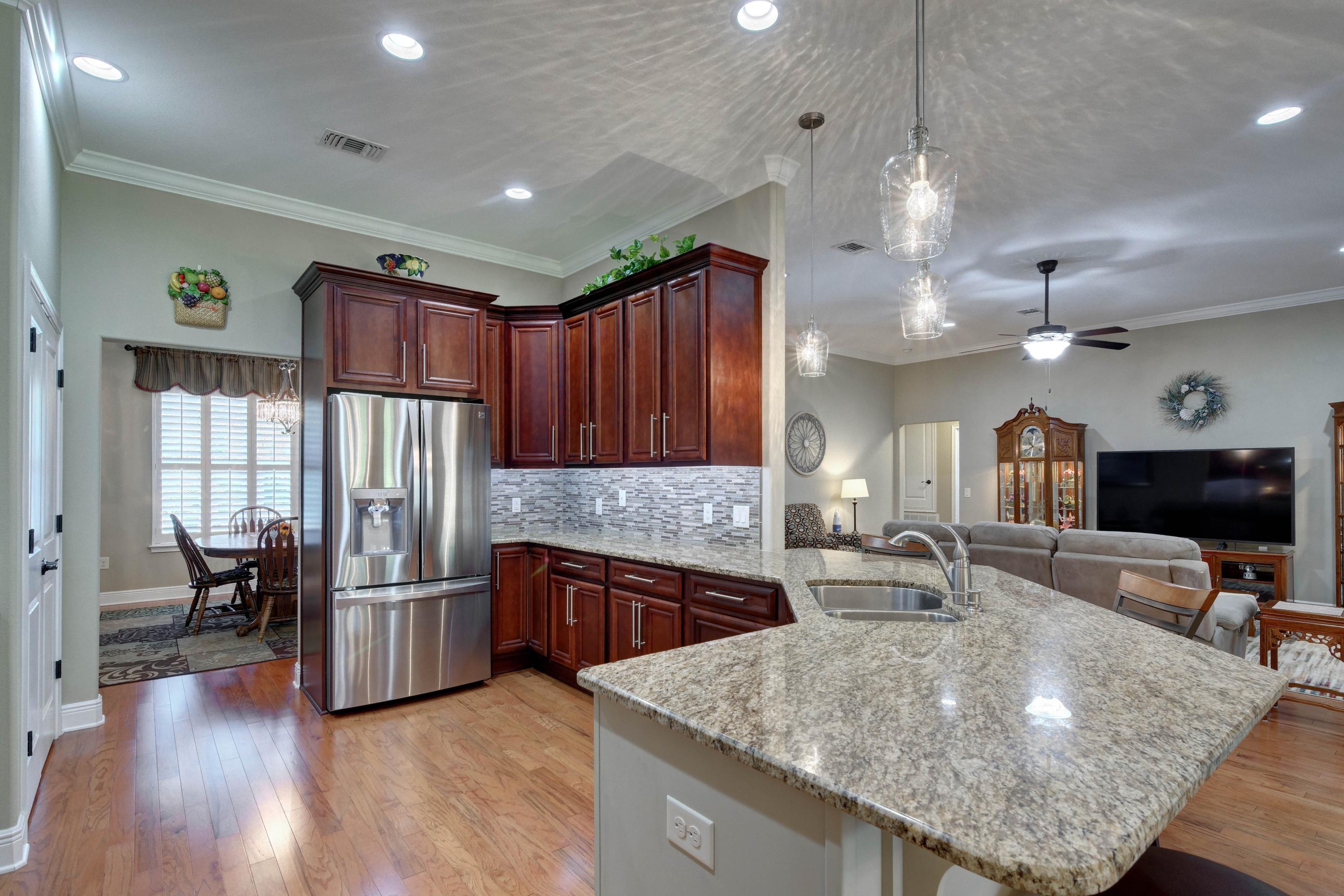 2592 Crescent Road Navarre, FL 32566 - Photo 18 of 67 a kitchen with stainless steel appliances granite countertop a sink refrigerator and cabinets