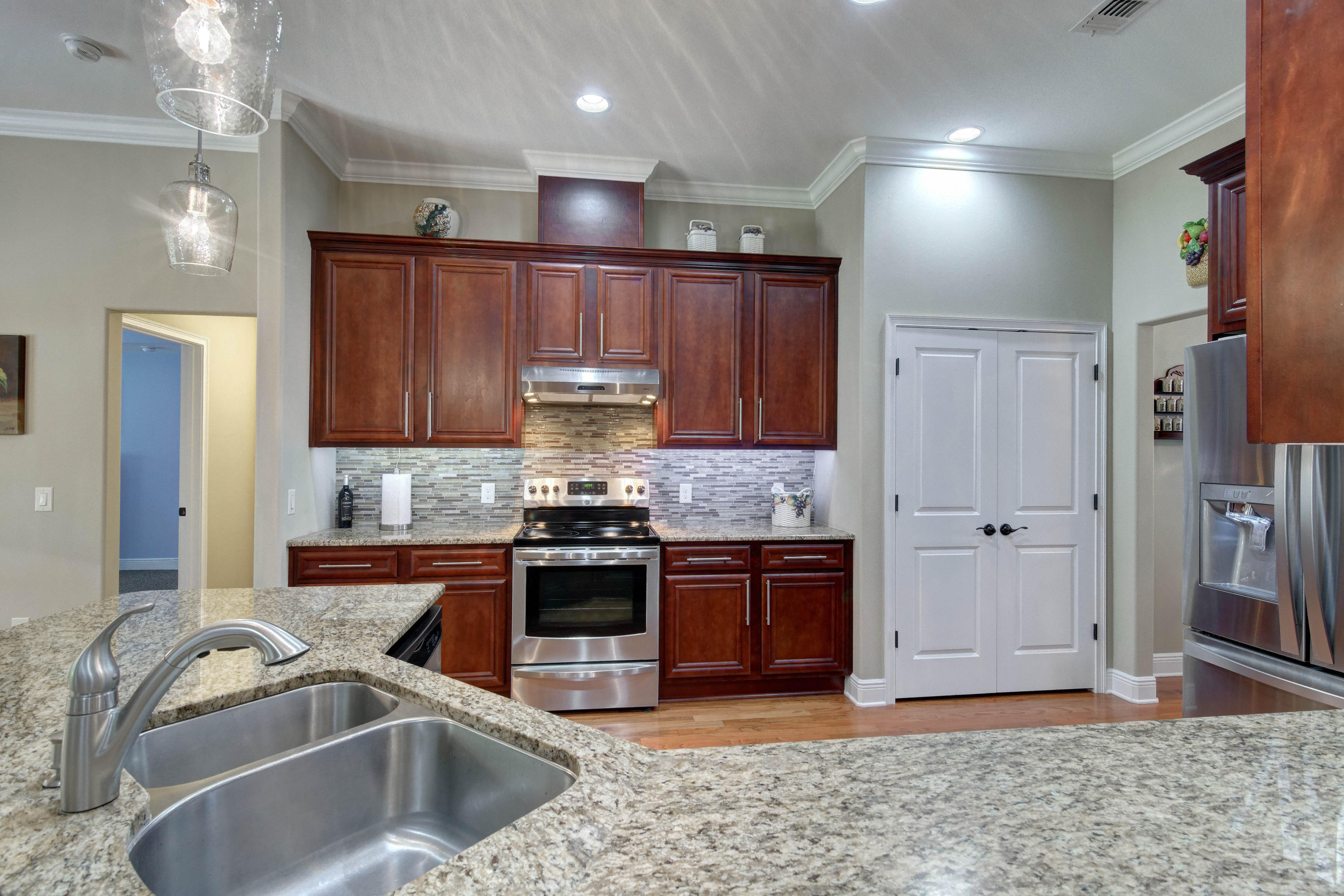 2592 Crescent Road Navarre, FL 32566 - Photo 20 of 67 a kitchen with kitchen island granite countertop a sink stainless steel appliances and cabinets