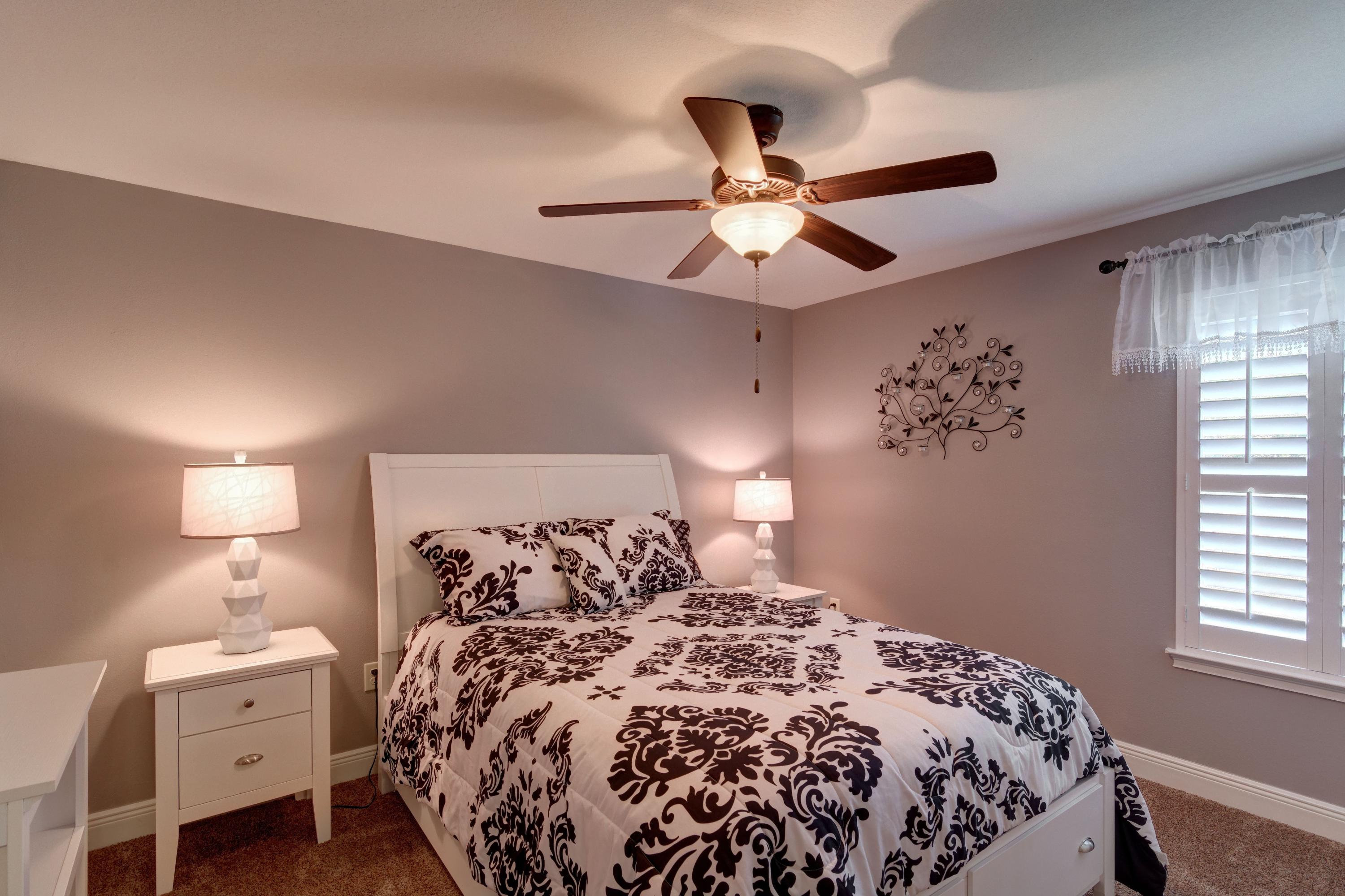 2592 Crescent Road Navarre, FL 32566 - Photo 35 of 67 a bedroom with a bed and a chandelier