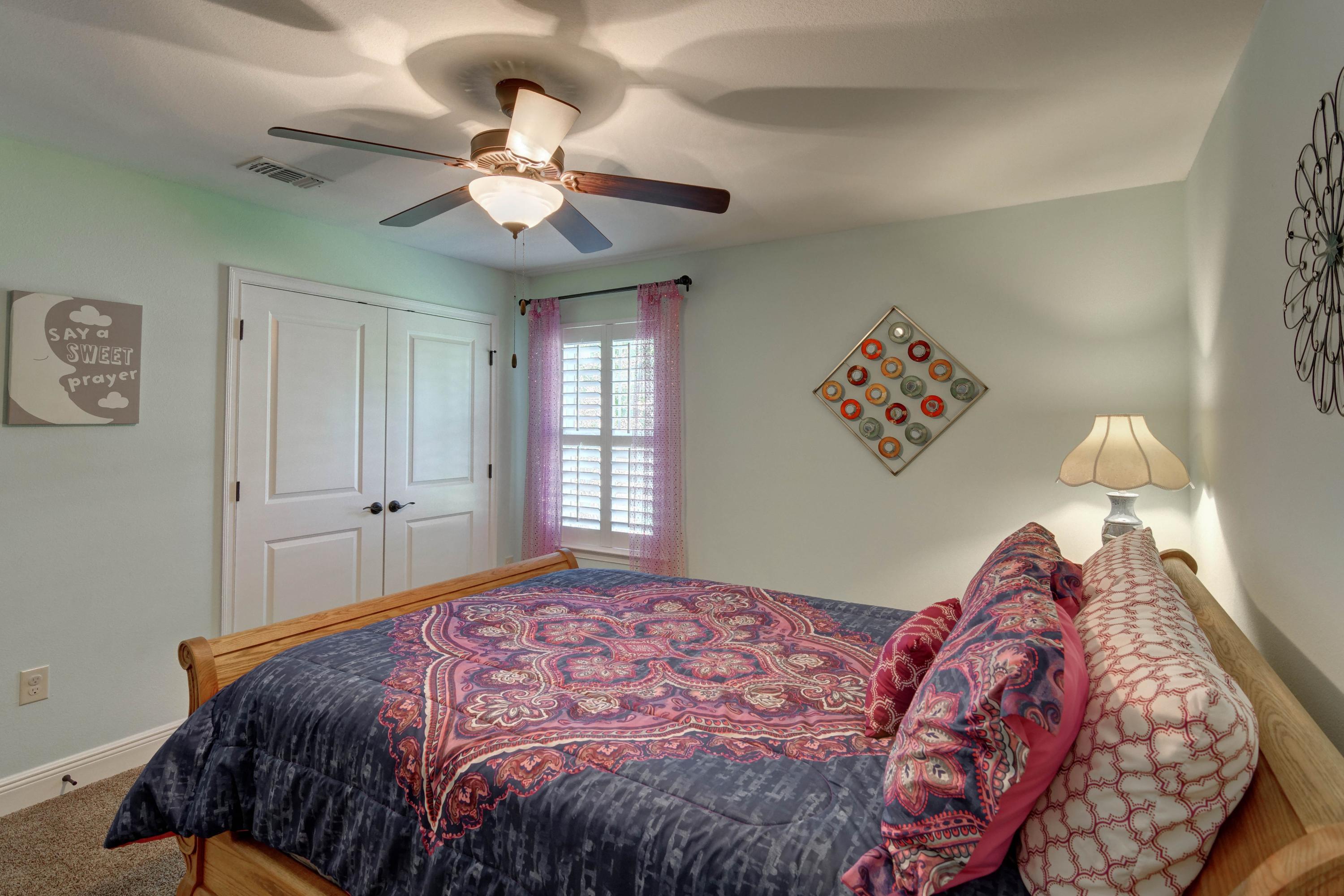 2592 Crescent Road Navarre, FL 32566 - Photo 41 of 67 a bedroom with a bed and a chandelier