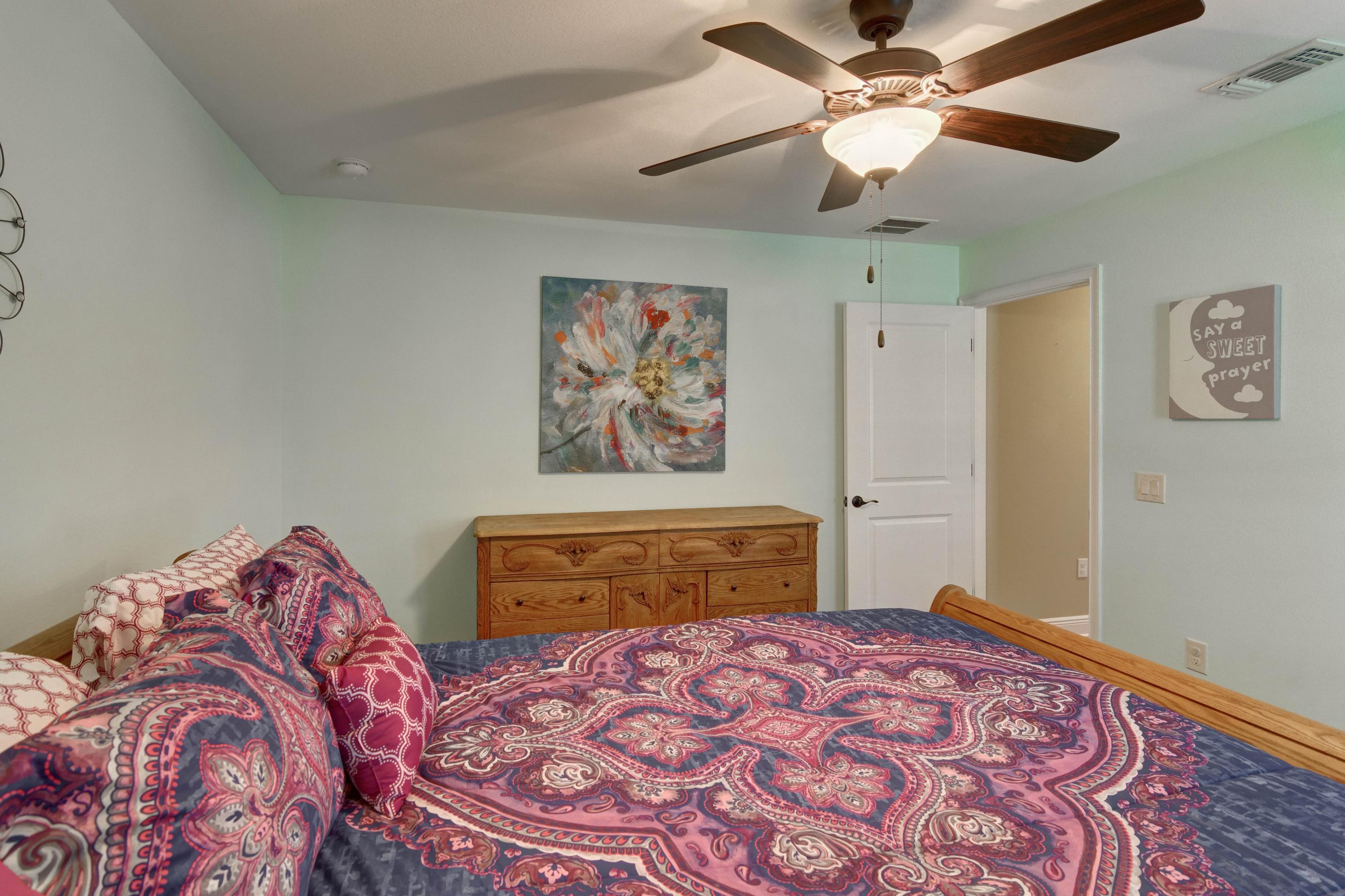 2592 Crescent Road Navarre, FL 32566 - Photo 42 of 67 a bedroom with a bed and a chandelier