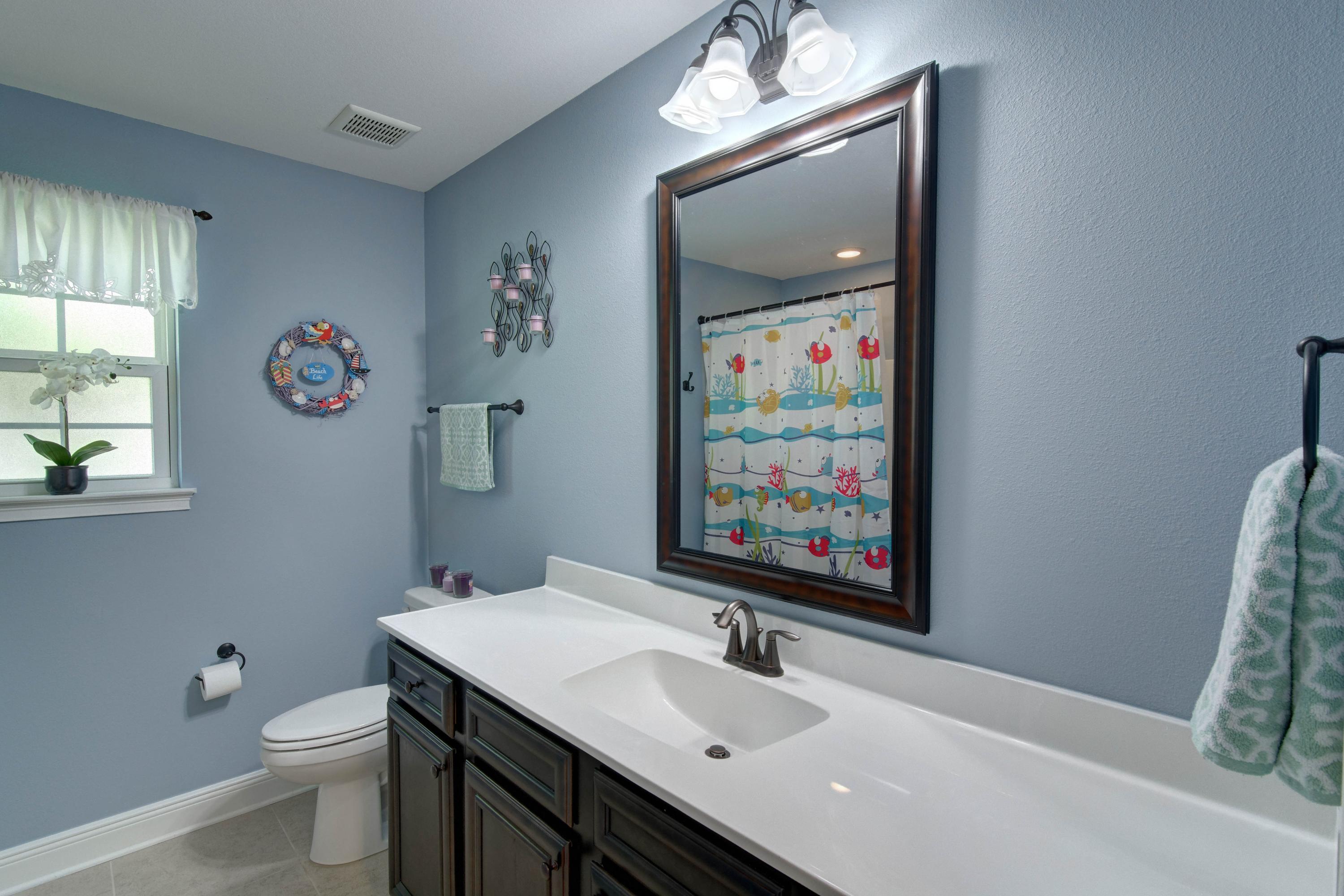 2592 Crescent Road Navarre, FL 32566 - Photo 43 of 67 a bathroom with a sink a toilet and a mirror