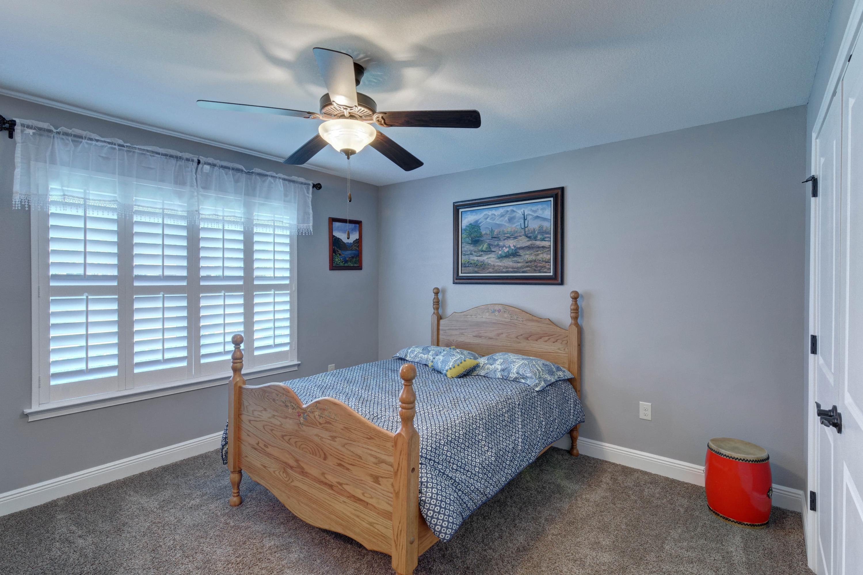 2592 Crescent Road Navarre, FL 32566 - Photo 45 of 67 a bedroom with a bed and a chandelier