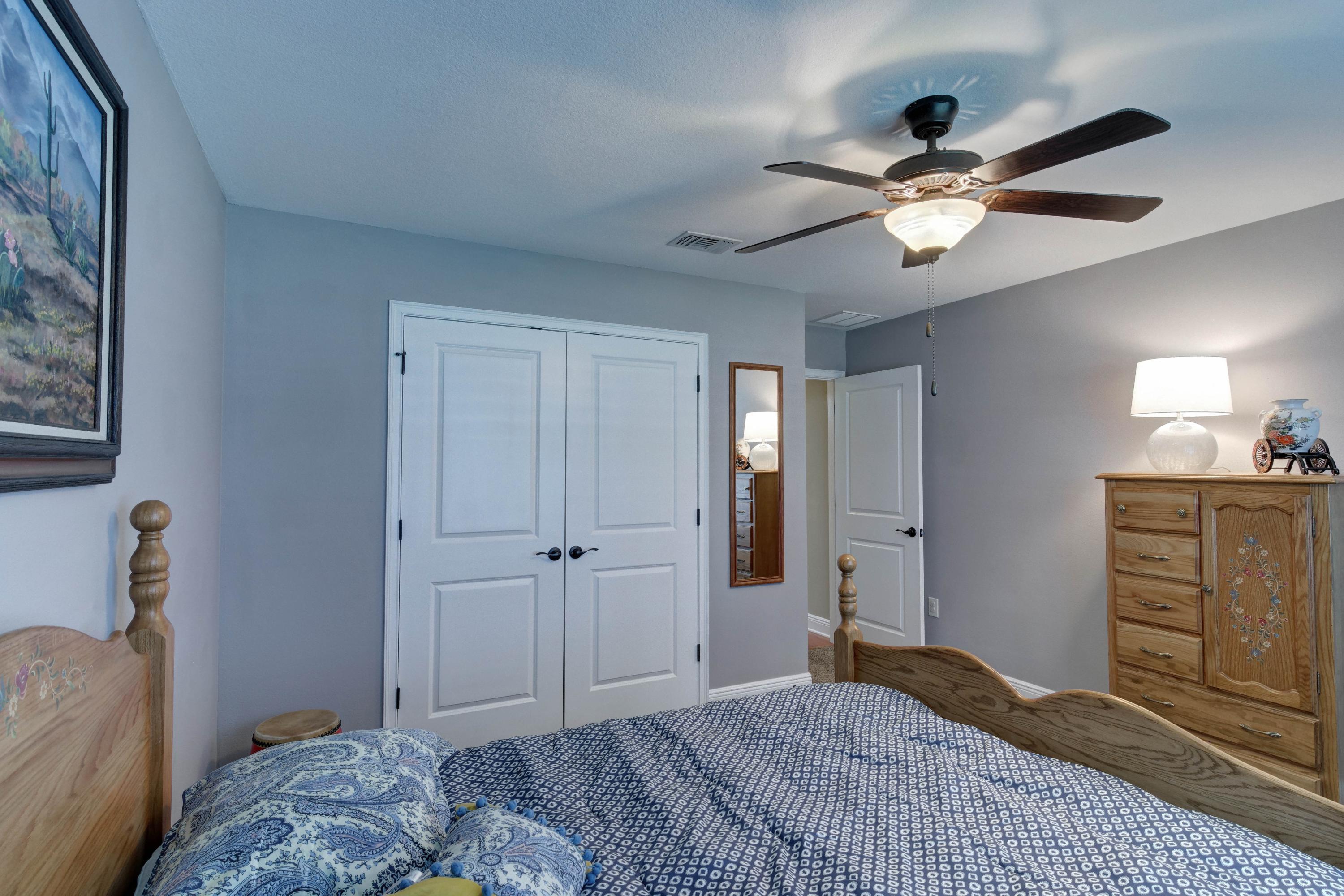 2592 Crescent Road Navarre, FL 32566 - Photo 47 of 67 a bedroom with a bed and a chandelier