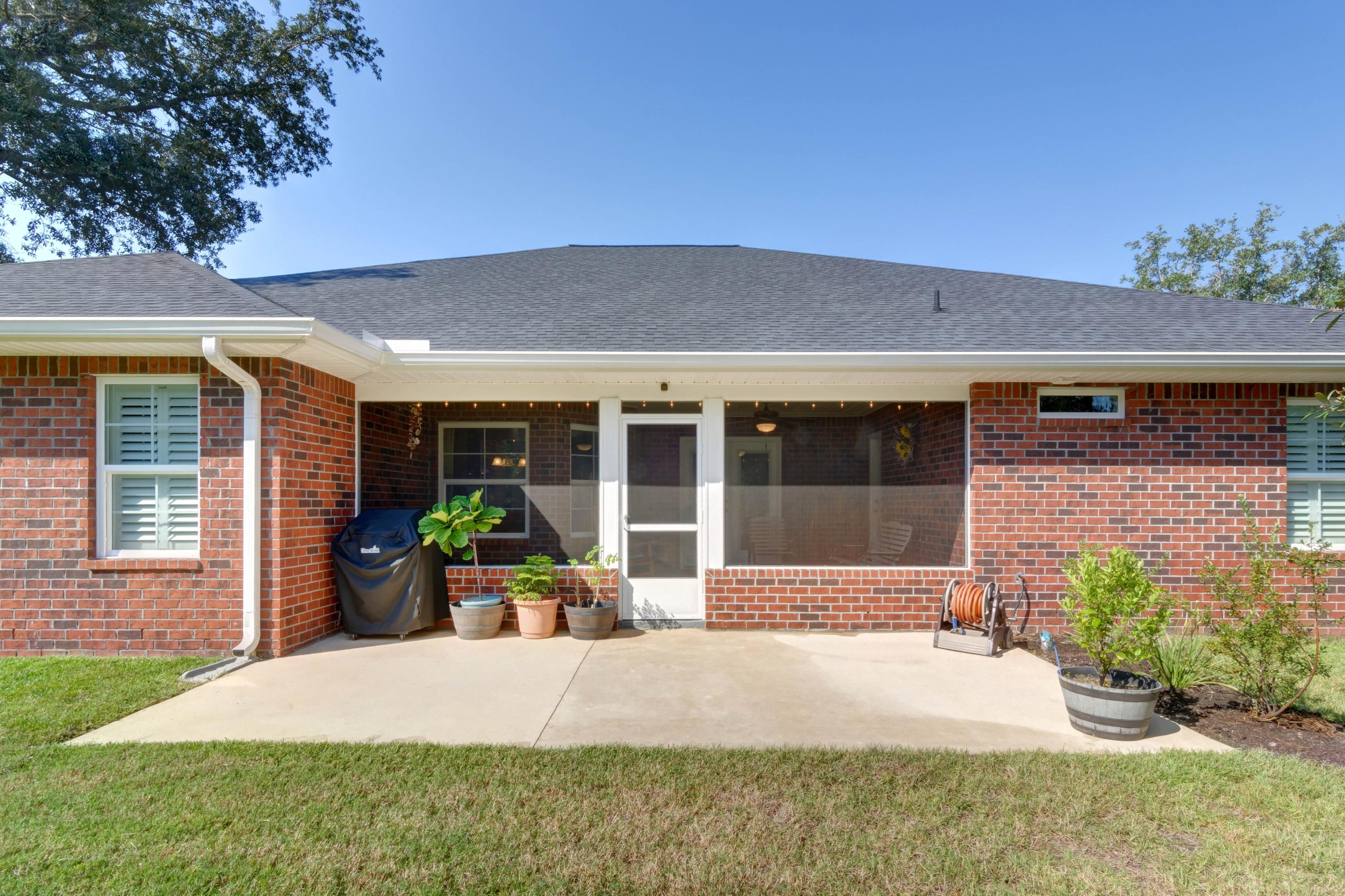 2592 Crescent Road Navarre, FL 32566 - Photo 52 of 67 a front view of a house with garden and porch