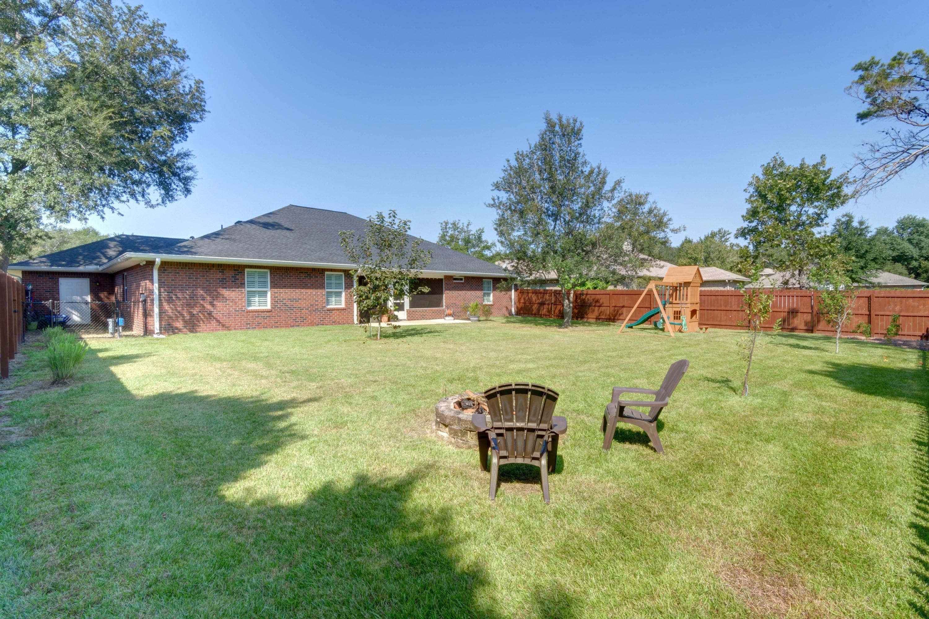 2592 Crescent Road Navarre, FL 32566 - Photo 56 of 67 a view of a house with a yard porch and sitting area