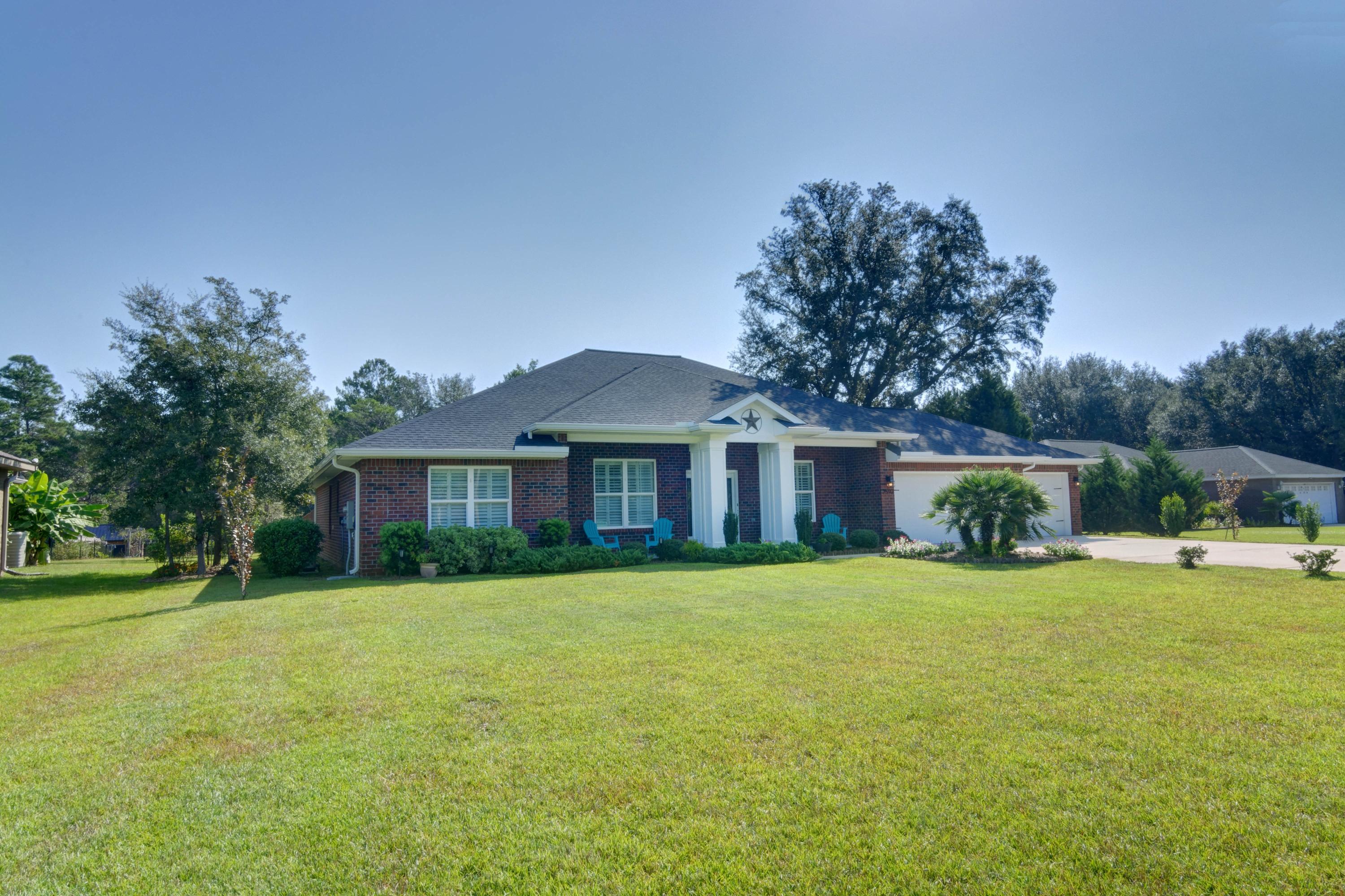 2592 Crescent Road Navarre, FL 32566 - Photo 60 of 67 a front view of house with yard and green space