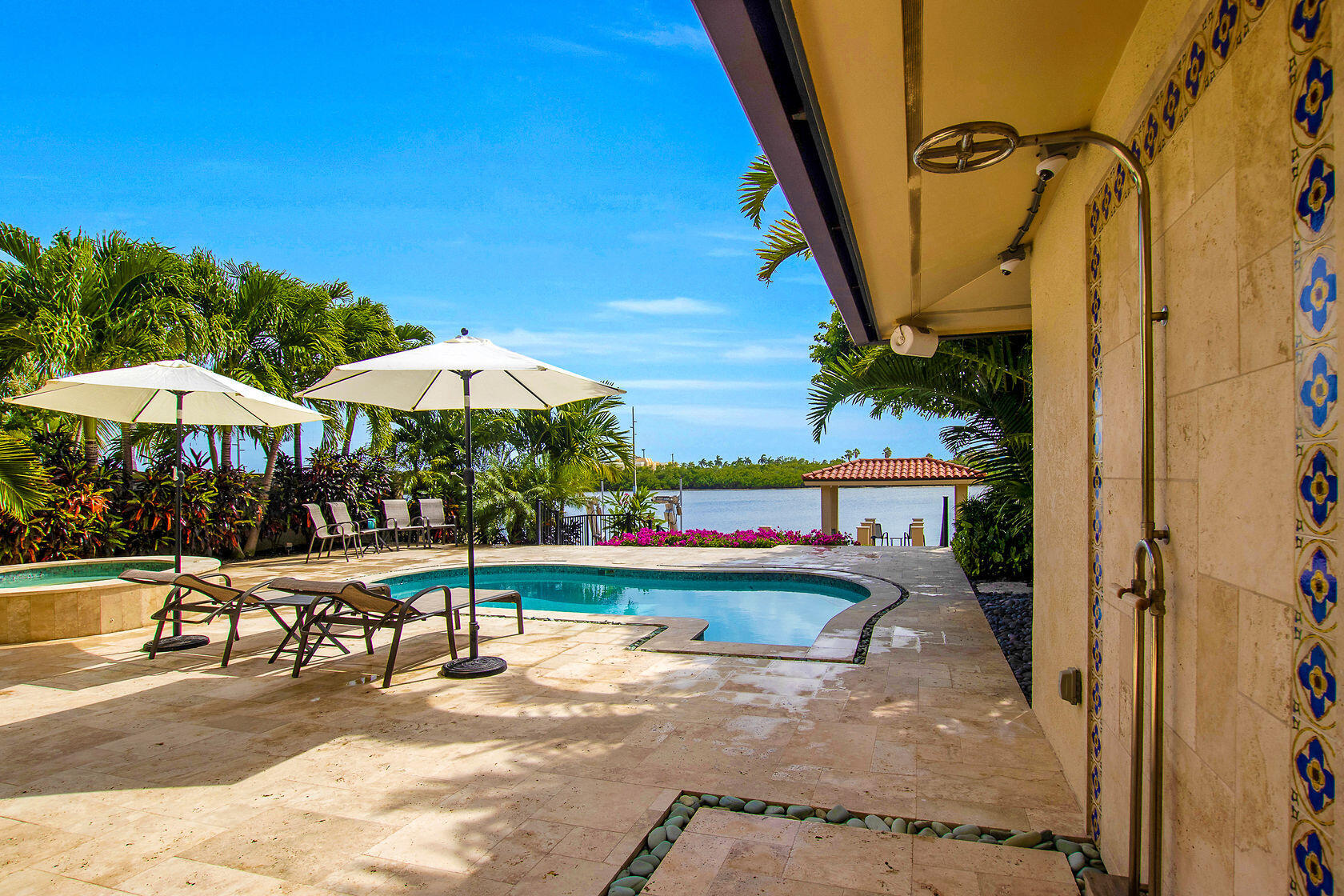 153 Key Haven Road Key West, FL 33040 - Photo 24 of 28 a view of a swimming pool with a table and chairs under an umbrella