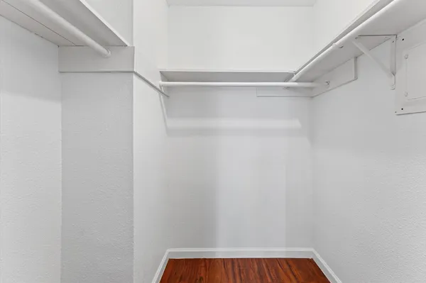 a view of walk in closet with empty racks