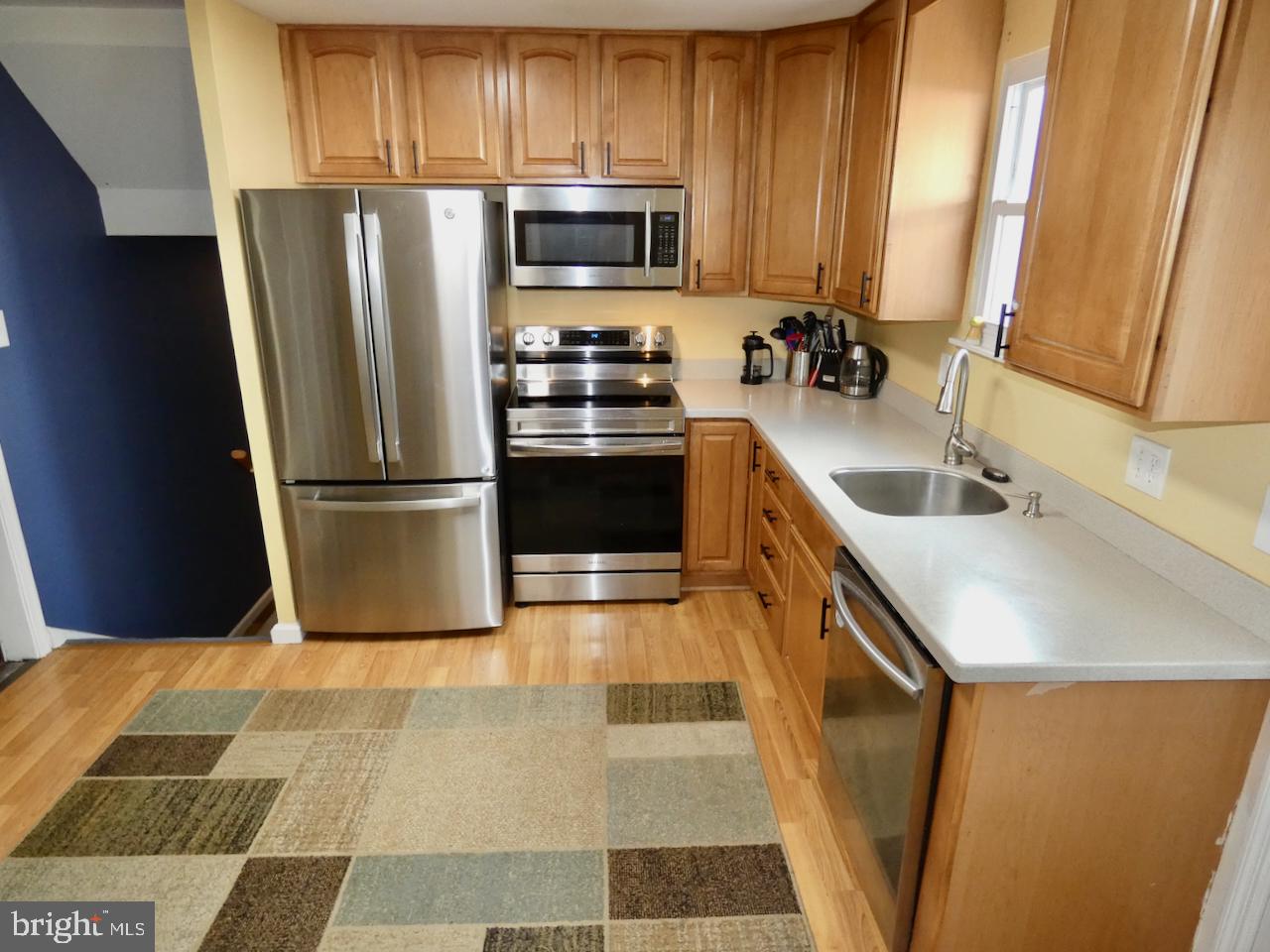 23 Upland Court Newark, DE 19713 - Photo 17 of 84 a kitchen with granite countertop a refrigerator and a sink