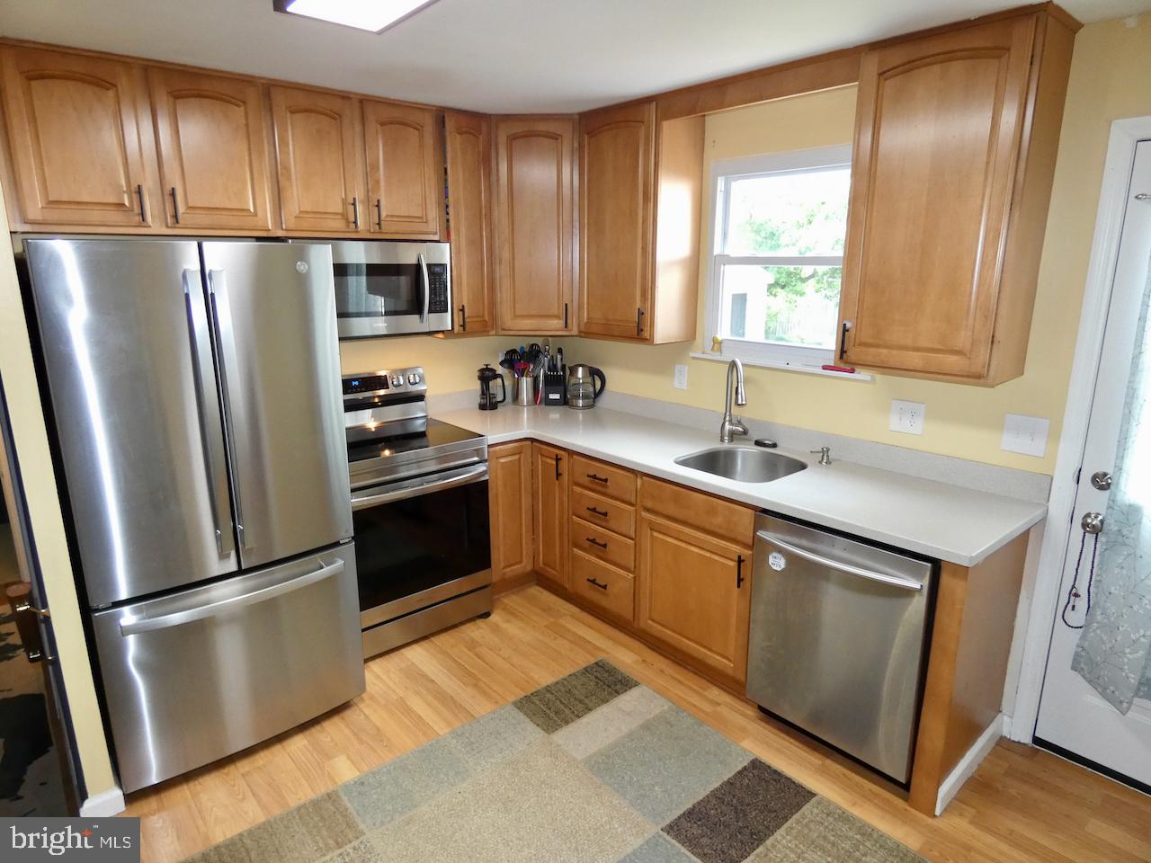 23 Upland Court Newark, DE 19713 - Photo 21 of 84 a kitchen with stainless steel appliances granite countertop a refrigerator stove and sink