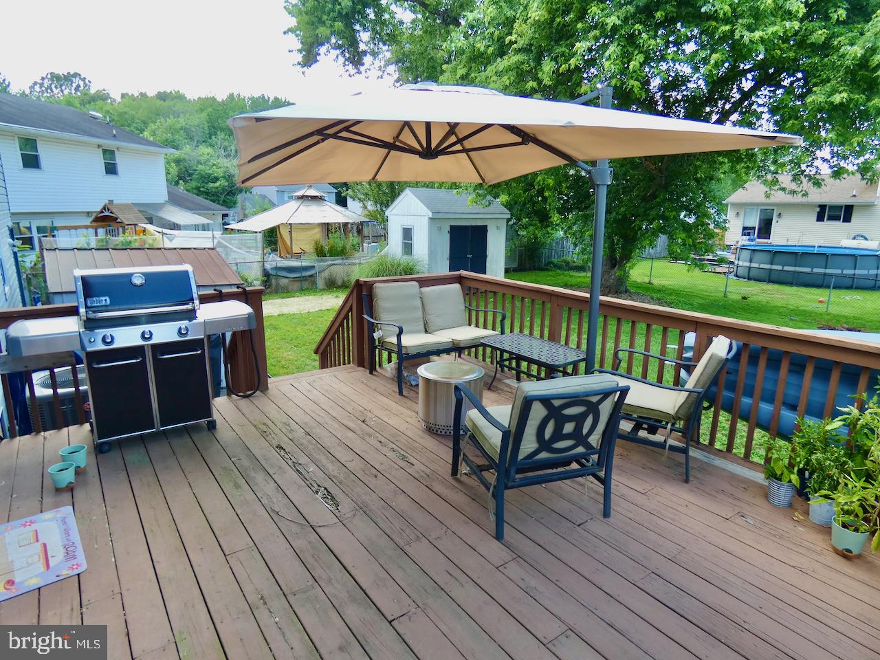 23 Upland Court Newark, DE 19713 - Photo 67 of 84 a view of a roof deck with table and chairs under an umbrella with wooden floor