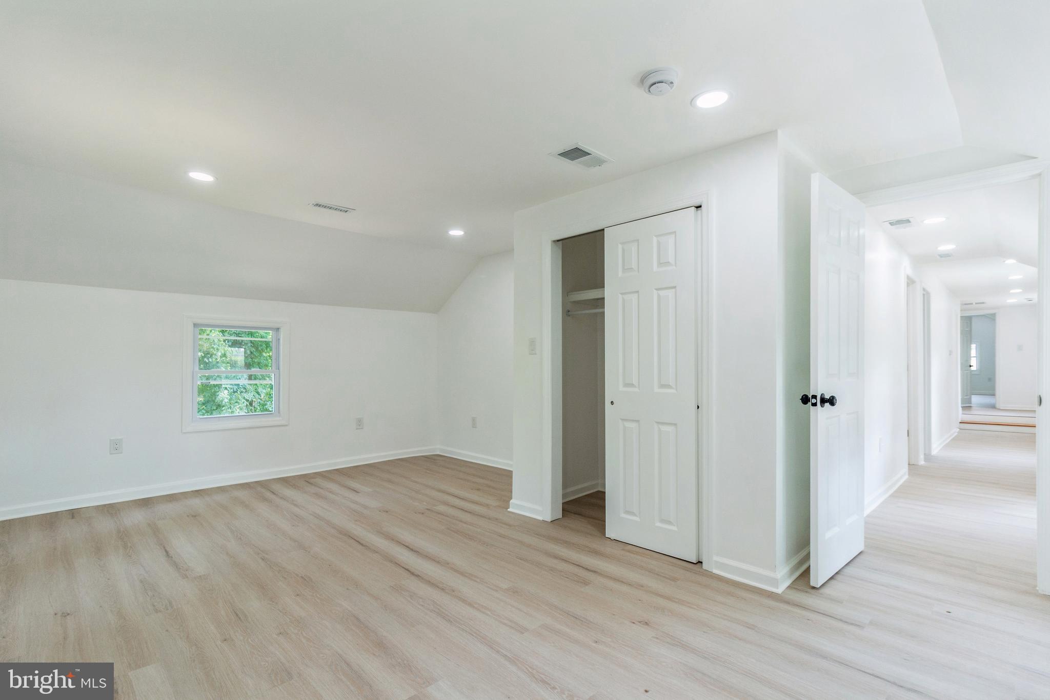 229 Shoemaker Road Bridgeton, NJ 08302 - Photo 13 of 29 an empty room with wooden floor and windows