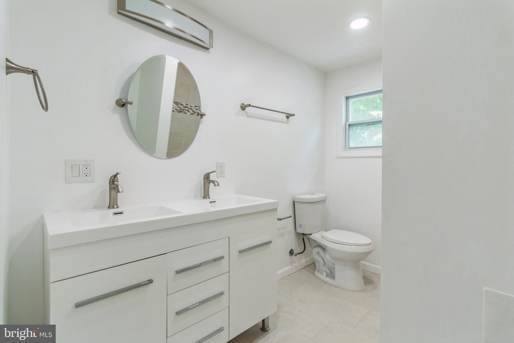 229 Shoemaker Road Bridgeton, NJ 08302 - Photo 18 of 29 a bathroom with a toilet sink and mirror