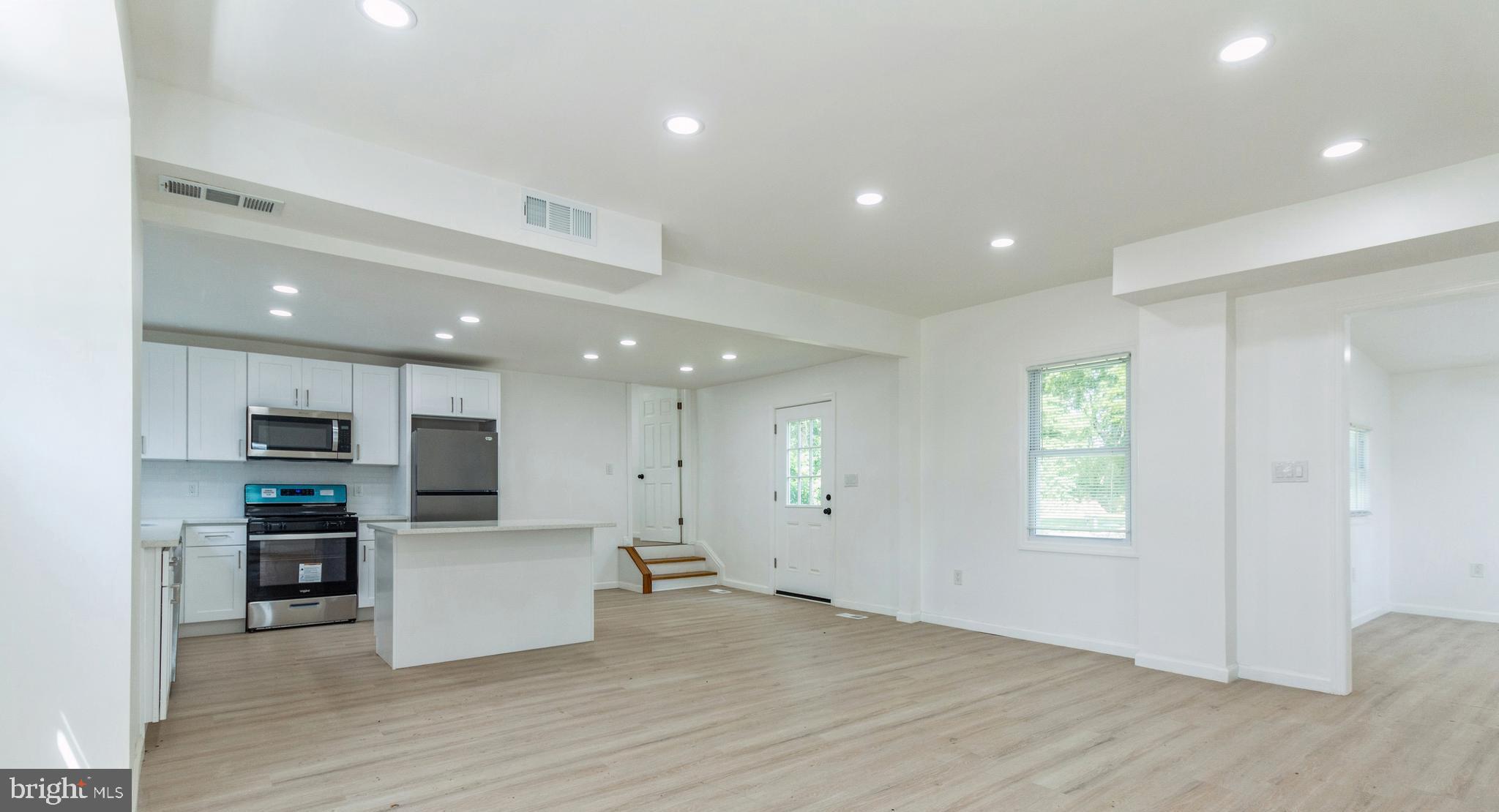229 Shoemaker Road Bridgeton, NJ 08302 - Photo 2 of 29 a view of kitchen with microwave a refrigerator and a stove top oven