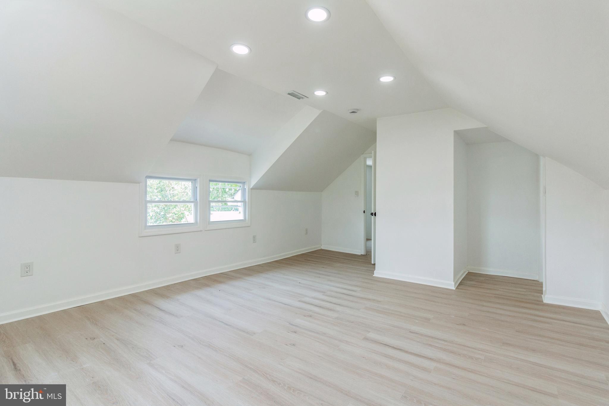 229 Shoemaker Road Bridgeton, NJ 08302 - Photo 21 of 29 an empty room with wooden floor and windows