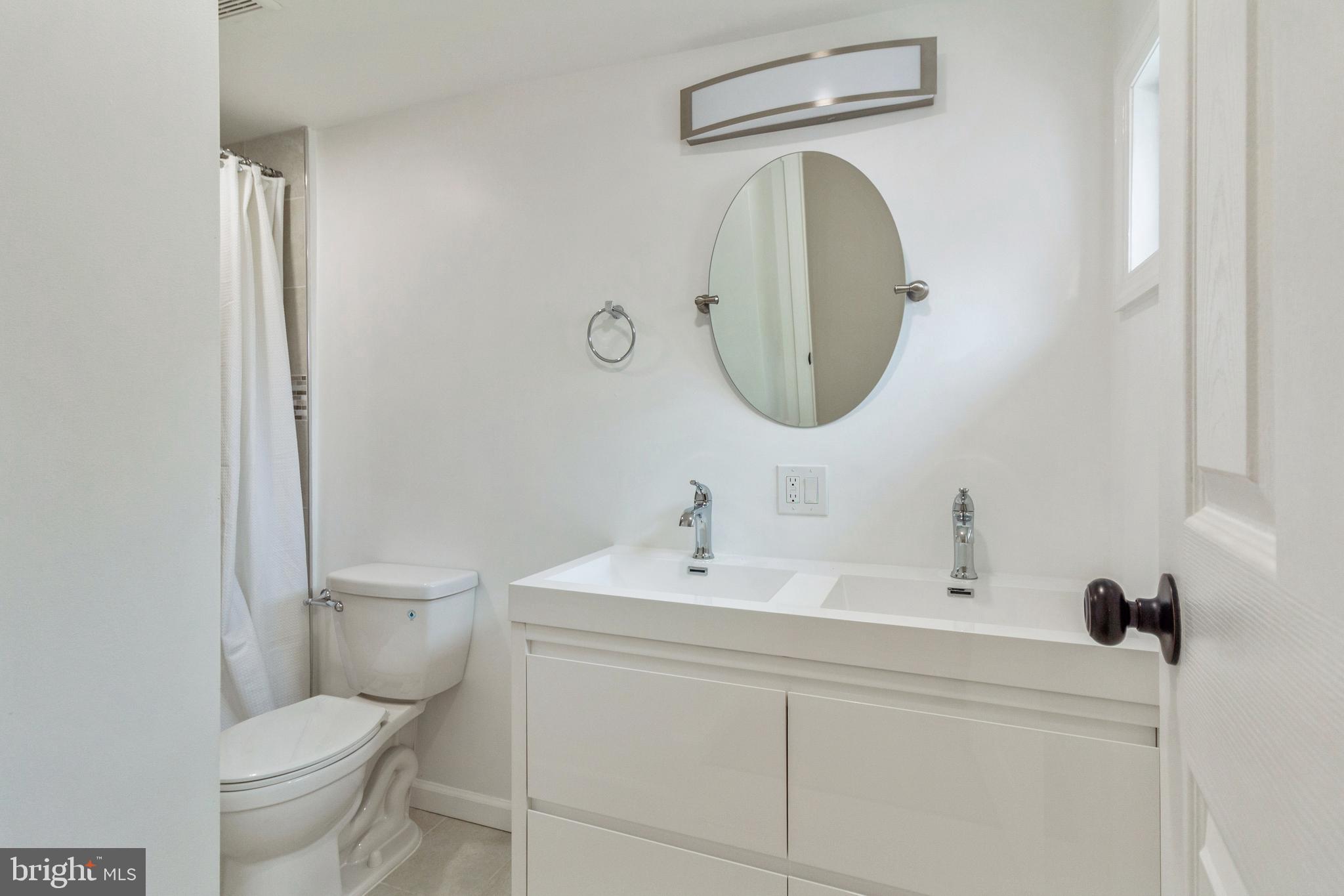229 Shoemaker Road Bridgeton, NJ 08302 - Photo 22 of 29 a bathroom with a toilet sink and mirror