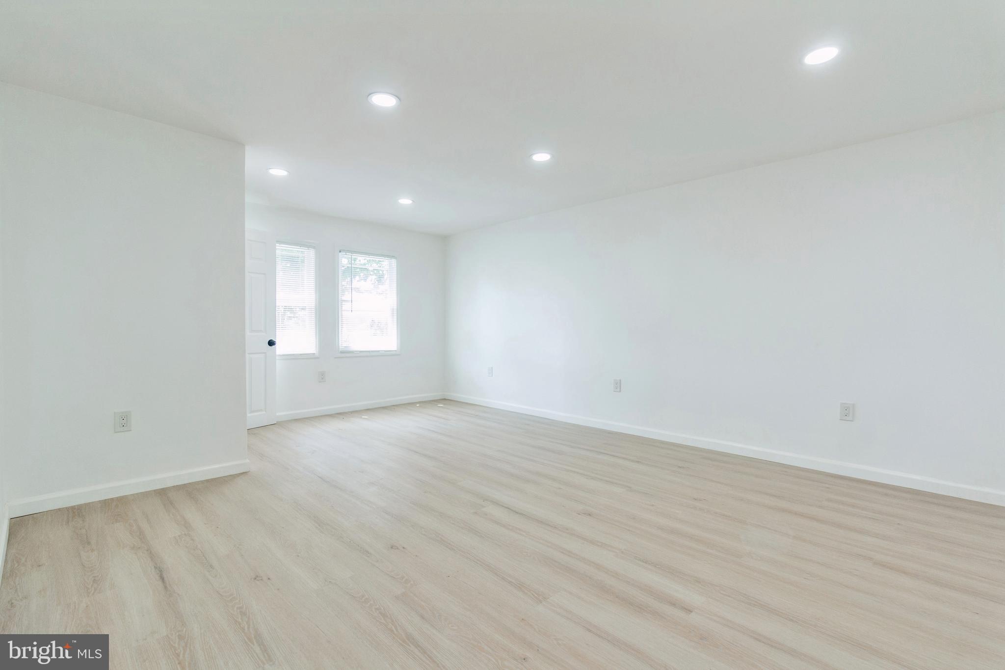 229 Shoemaker Road Bridgeton, NJ 08302 - Photo 5 of 29 an empty room with wooden floor and windows