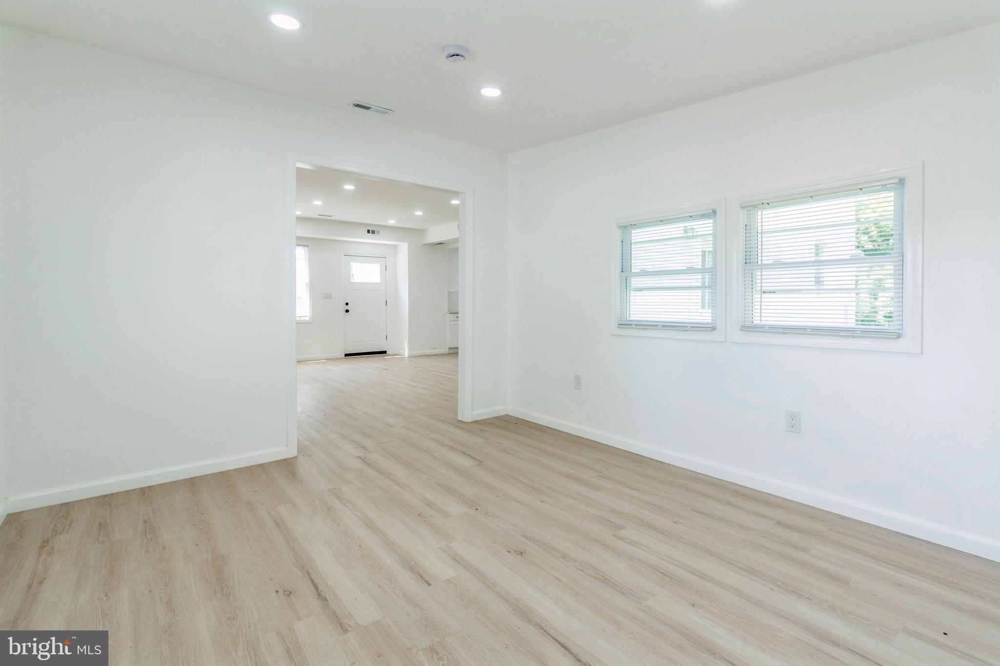 229 Shoemaker Road Bridgeton, NJ 08302 - Photo 7 of 29 an empty room with wooden floor and windows