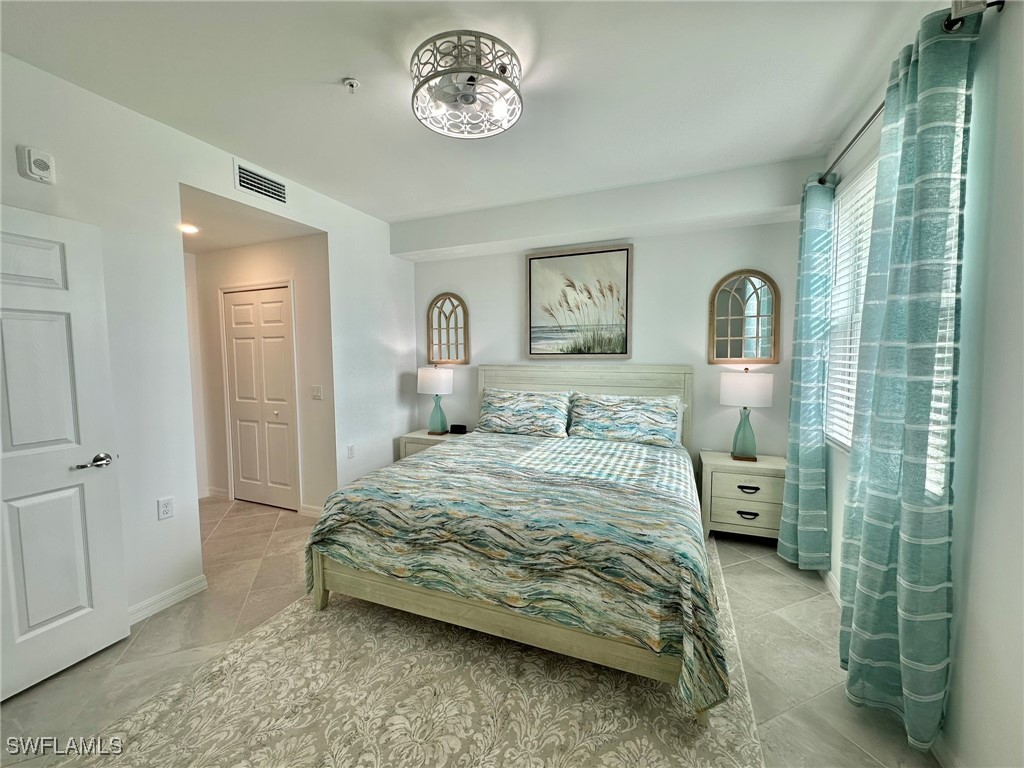43989 Boardwalk Loop, Unit 2018 Coffeyville, KS 67337 - Photo 5 of 29 a bedroom with a bed and a chandelier