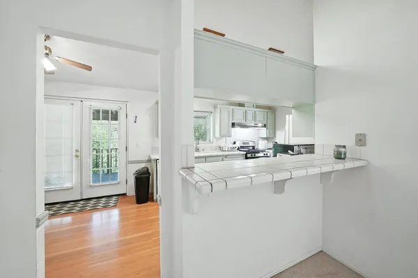 an empty room with a window and a fan