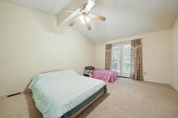 a view of a house with wooden fence
