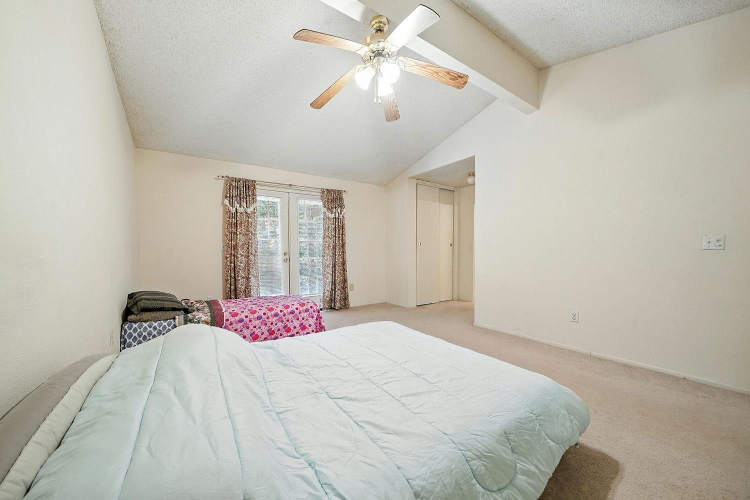 16000 Sutter Creek Road Sutter Creek, CA 95685 - Photo 23 of 80 a bedroom with a bed and a chandelier