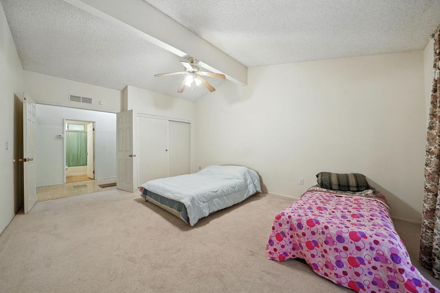 16000 Sutter Creek Road Sutter Creek, CA 95685 - Photo 24 of 80 a bedroom with two beds and a chandelier