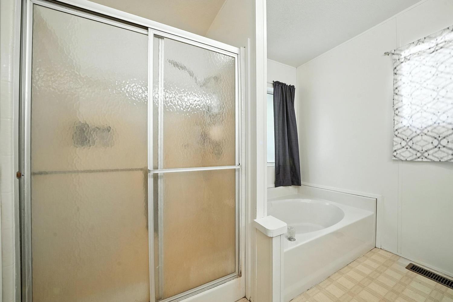 16000 Sutter Creek Road Sutter Creek, CA 95685 - Photo 26 of 80 a bathroom with a bathtub and a shower