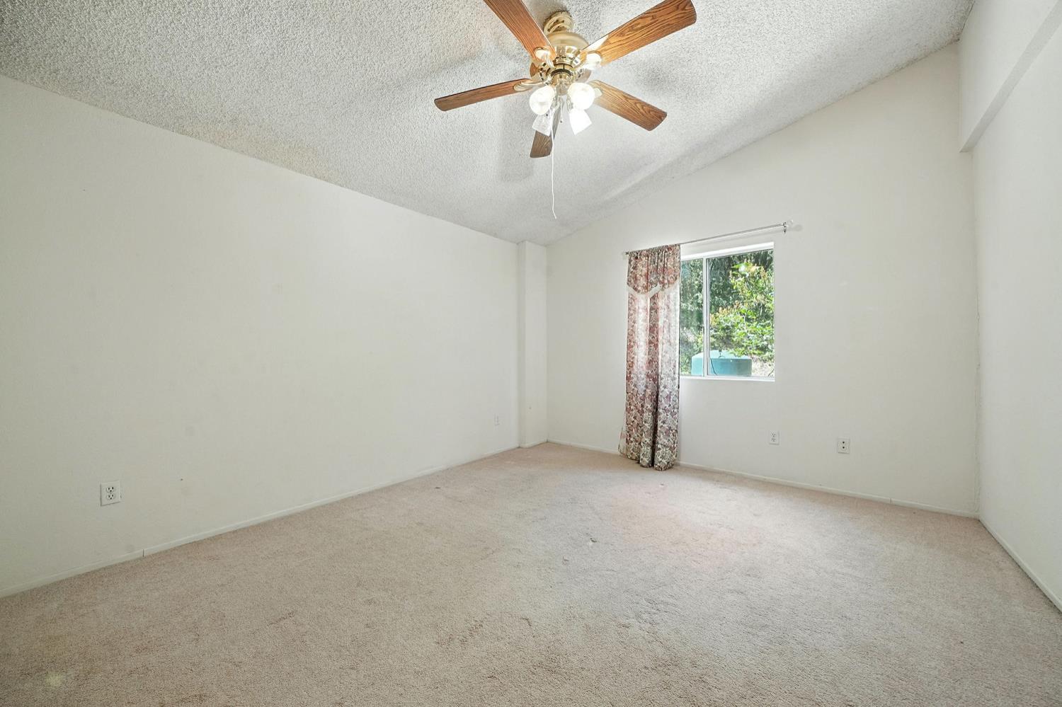 16000 Sutter Creek Road Sutter Creek, CA 95685 - Photo 27 of 80 an empty room with a window and a fan