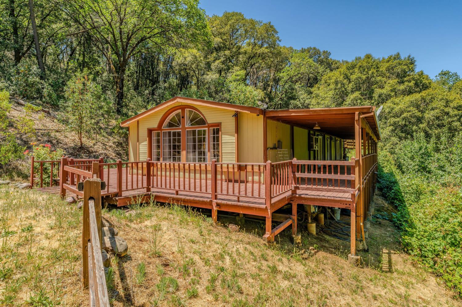 16000 Sutter Creek Road Sutter Creek, CA 95685 - Photo 34 of 80 a view of a wooden house with a small yard and wooden fence