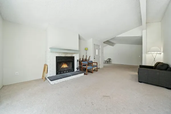 an empty room with a cabinet and mirror