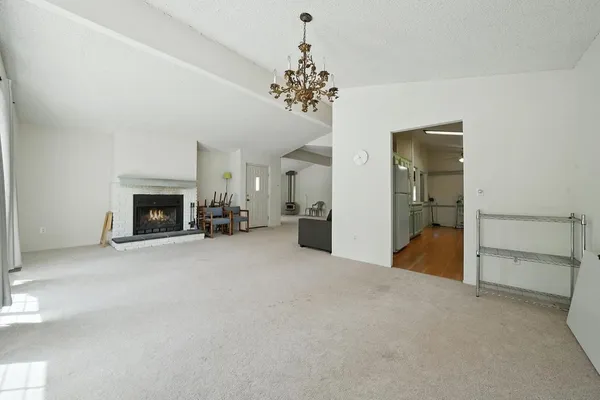 a kitchen with a sink a refrigerator a counter top space and cabinets