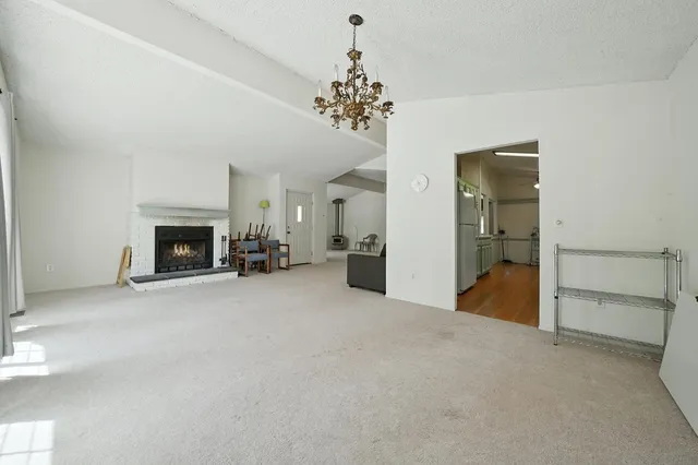 a kitchen with a sink a refrigerator a counter top space and cabinets