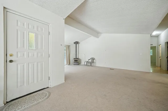 a bedroom with a bed dresser and a window