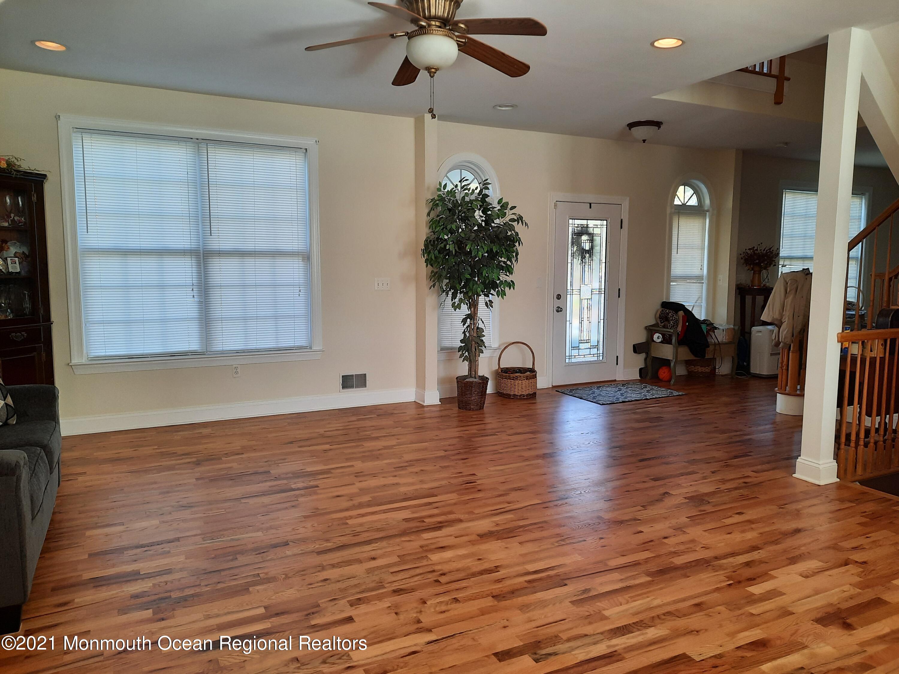 607 Dave Marion Road Toms River, NJ 08753 - Photo 6 of 9 a view of a room with wooden floor and a ceiling fan
