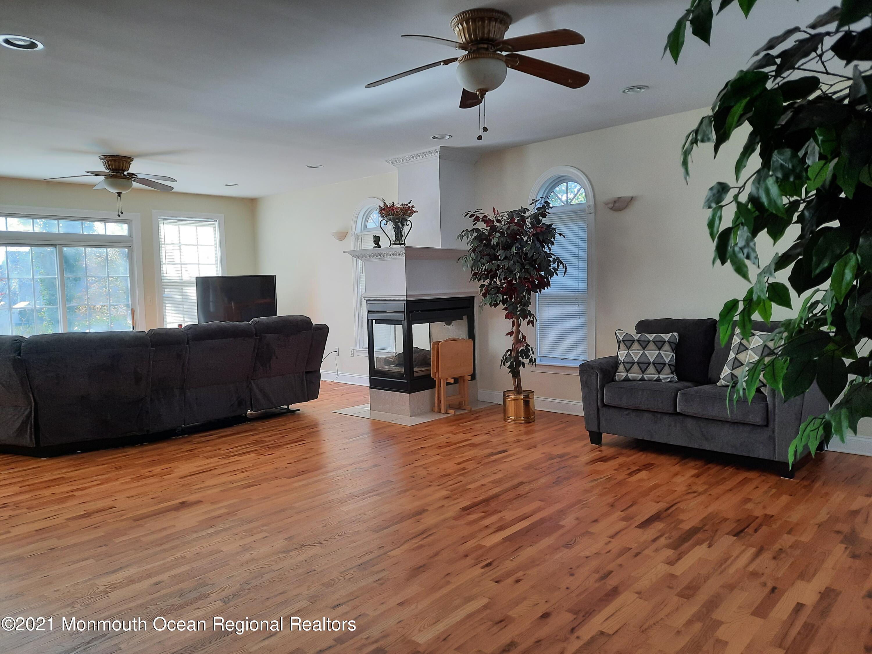 607 Dave Marion Road Toms River, NJ 08753 - Photo 9 of 9 a living room with furniture and a fireplace