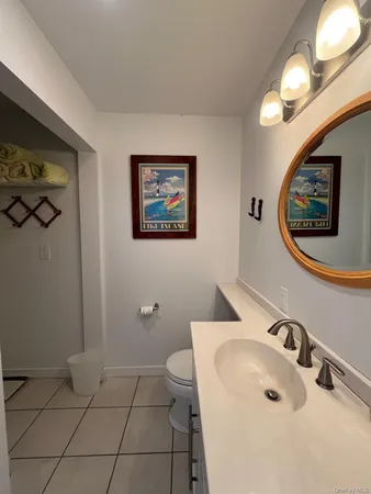 a bathroom with a sink a toilet and mirror