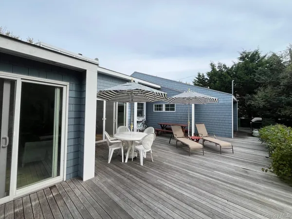 a view of a house with backyard porch and sitting area