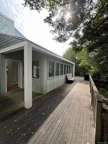 a view of house with a deck