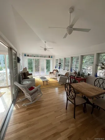 a living room with furniture a table and wooden floor
