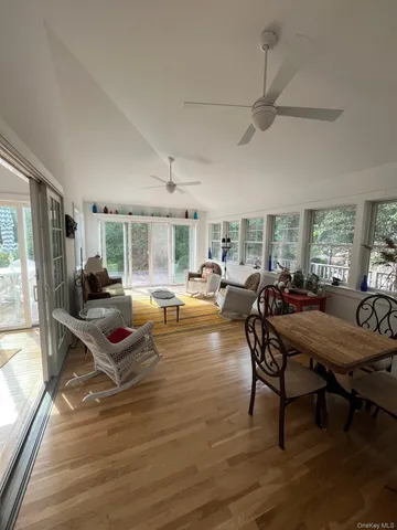 a living room with furniture a table and wooden floor