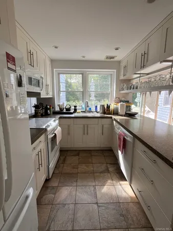 a kitchen with stainless steel appliances granite countertop a sink and cabinets