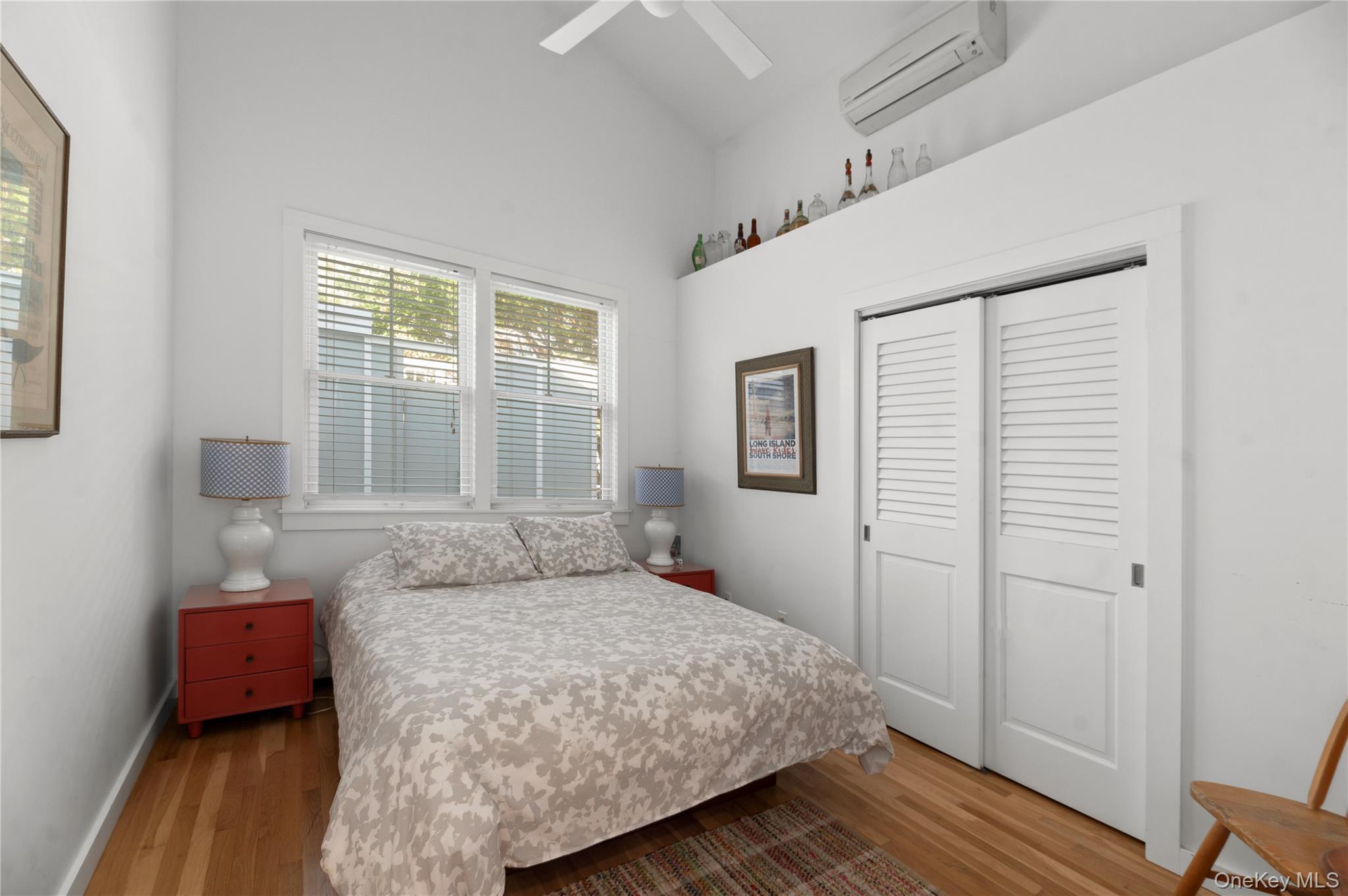 55 Ocean Road Ocean Beach, NY 11770 - Photo 10 of 14 a bedroom with a bed and wooden floor